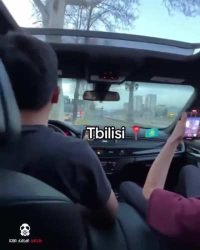 Kazakh foreigners driving on sidewalk during rush hour.