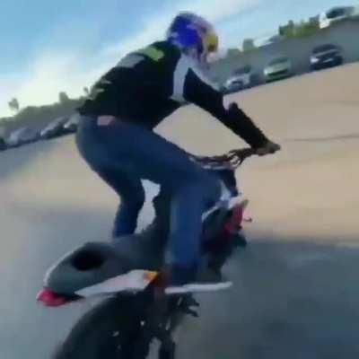 The way this biker gets off the motorcycle and parks it with the kickstand.