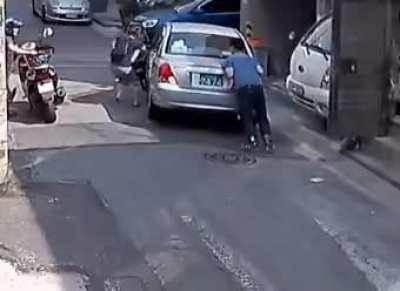 A passing woman jumps in to help a man whose runaway car was stuck in reverse