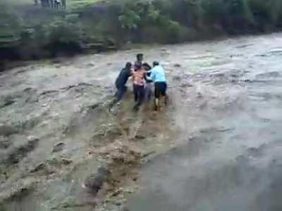 Family getting carried away by flash flood