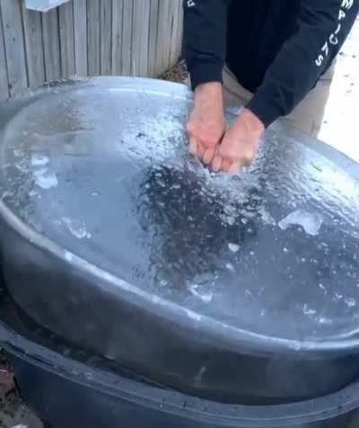 Pulling ice out of a water tub on a Canadian winter morning