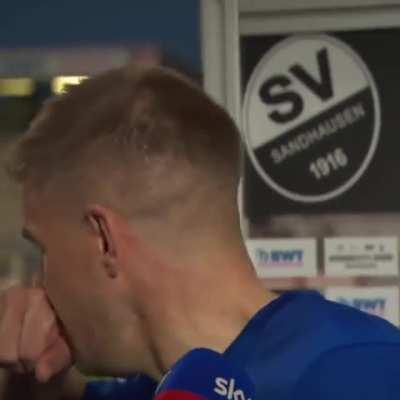 Simon Terodde tries to give an interview after scoring last minute winner