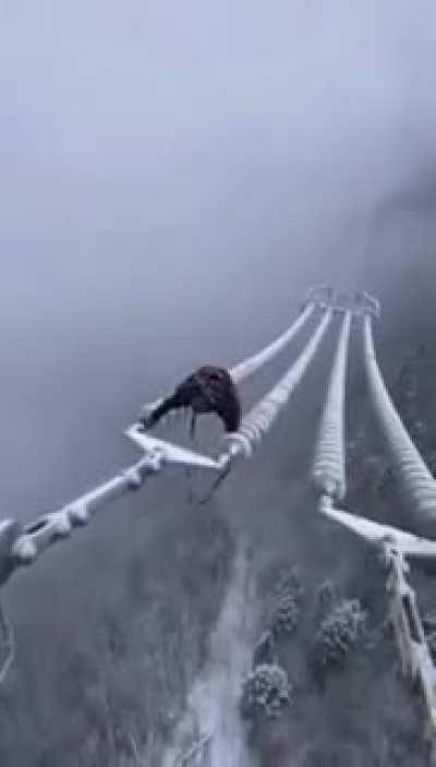 Cable line worker making his way back in snowy conditions