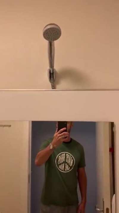 American gets a hotel room in Denmark, discovers hidden shower stall.