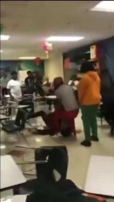 Teacher restrains students