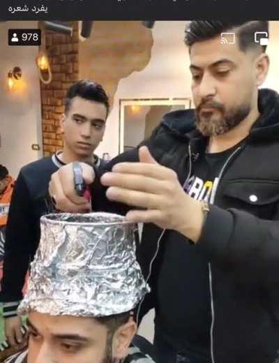 This Egyptian barber/chef giving a haircut and cooking kebabs on his client’s head