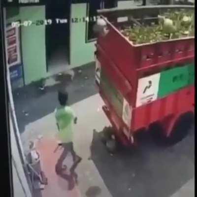 Attempting to throw a gas tank into a cargo truck
