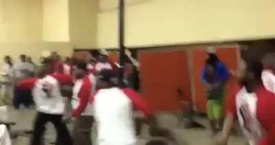 Woman throws table at mob, blocks one chair, catches the other, all while holding her purse