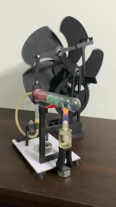 Marble Stirling engine powered 5 blade table fan. Linear motion to rotation motion using beam mechanism. Alcohol as fuel source, 5:1 gear ratio