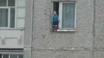 Russian Kid Checks Out The View From His Window.