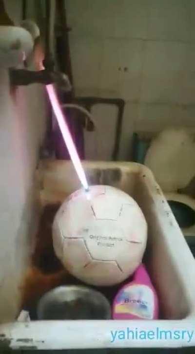 Blowing up a soccer ball.