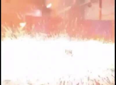 Man smashing a heated ball with hammer