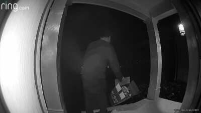 Trashy adult trick-or-treater with no costume helps himself to entire box of candy meant for children.