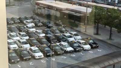 Taxis in Japan line up in an orderly fashion to pick up passengers