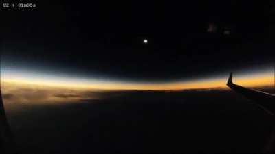 A solar eclipse happening mid-flight