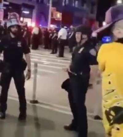 Cop does the white power sign while his colleagues laugh