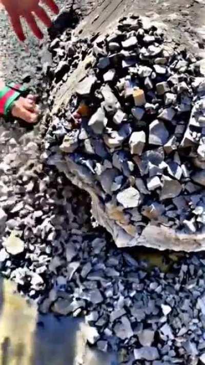 This stone effortlessly crumbling into smaller rocks