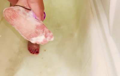 Soapy pale feet with sparkly red polish are a perfect match in heaven