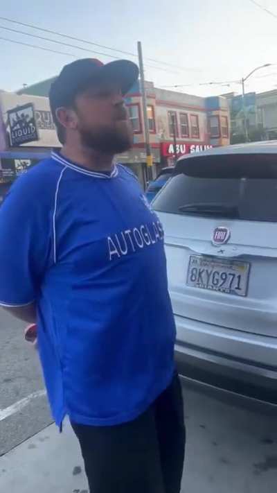 Drunk man has his leg touched by protestors sign after 