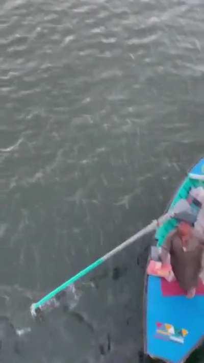 Street vendors selling stuff in middle of ocean to cruise ship passengers.