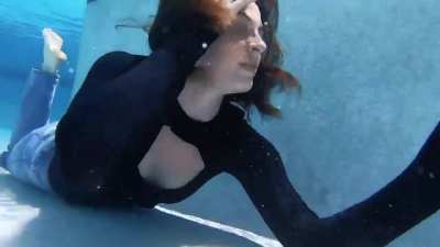 Lana Lohan blows bubbles underwater fully clothed