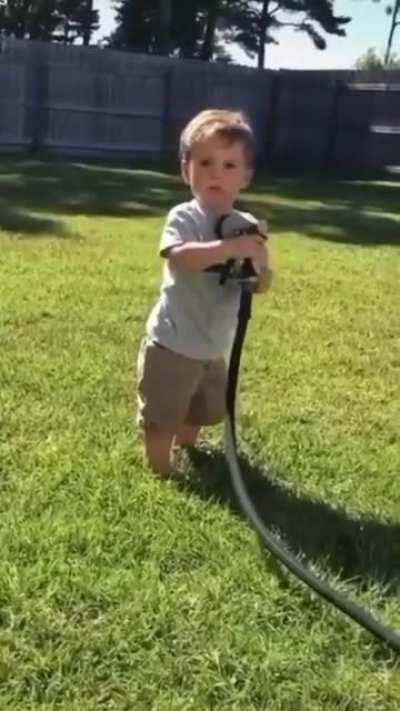 Trying to water the grass with the garden hose