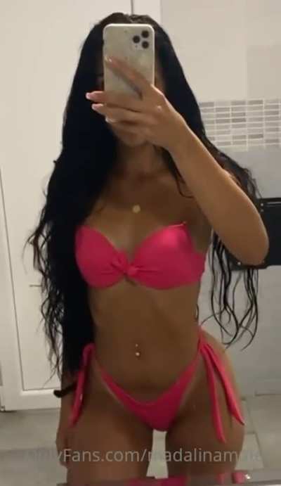Mădălina Mateș flaunting her pink thong bikini in front of the mirror.