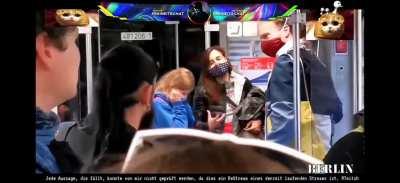 This german family gets yelled at because they have masks on. The crowd shouts: 