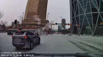 Calgary Transit bus snow drifting into traffic light