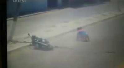 Man crashes bike, bike hits pole, pole lands on man's head.