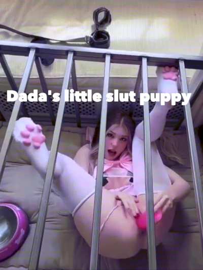 Cute girl plays with a dildo while being in a cage