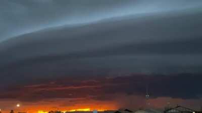 Shelf cloud with a sunset in the background