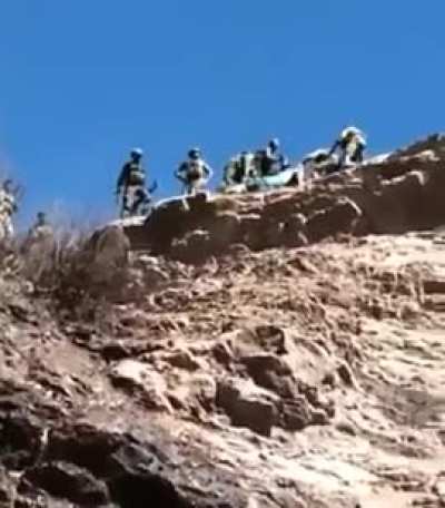 Turkish Commandos throw the corpse of a PKK terrorist from a cliff post-ambush