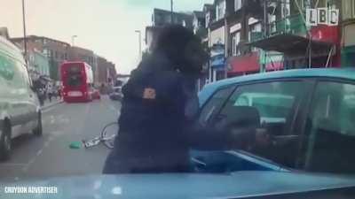 Guy tries to smash someone's car window with huge knife