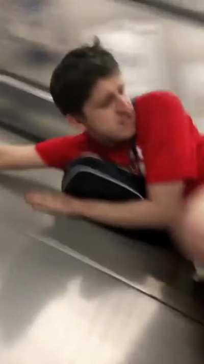 Sliding down escalator
