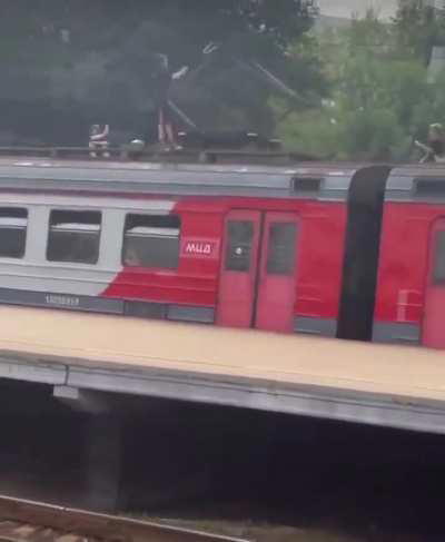Kids casually playing with a train high voltage pantograph