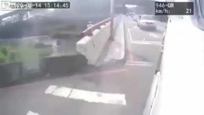 Scooterist cutting off a truck flips over a wall