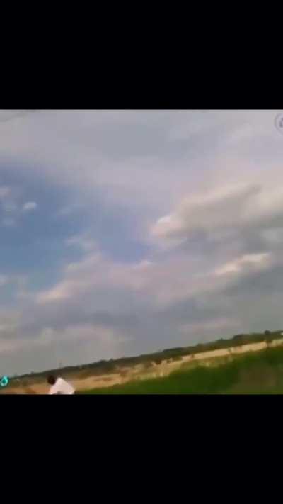 Guy throws rocks covered in copper wire at a power line, wonder what happens?