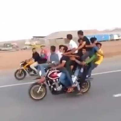 Popping wheelies with 12 people on board.