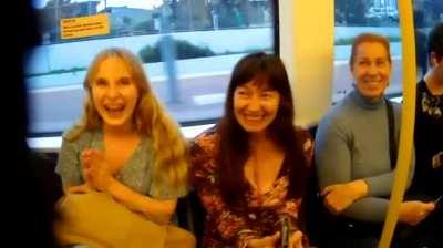 man spreading his laughter with the people on a train.