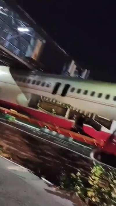 WCGW driving a truck loaded with a fuselage under a bridge