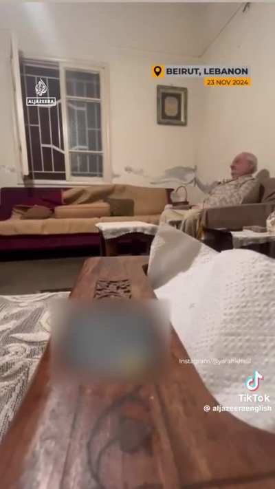 Lebanese man appears unfazed by a violent Israeli attack in Beirut.