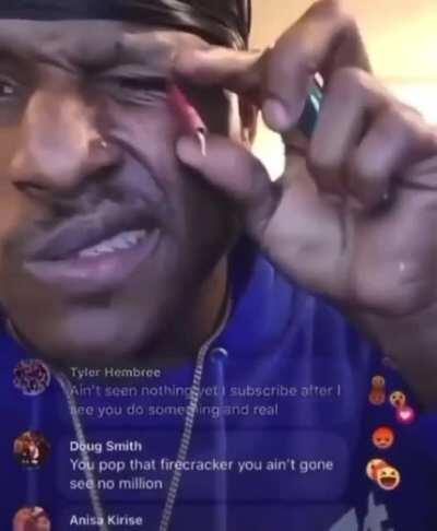 man lights fire cracker in his eye