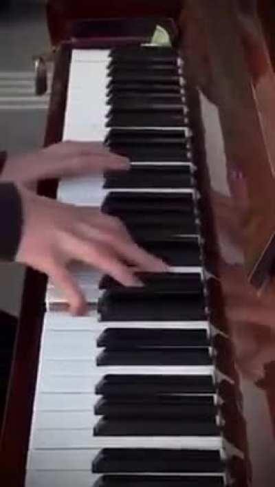 Pianist playing Hans Zimmer's Time in the streets of Kyiv while the air raid sirens wail.