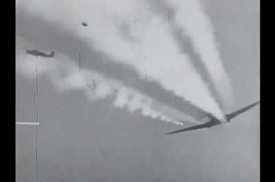 Bf 109 pilot with Jagdgeschwader 53 forces an RAF Spitfire to break off his attack on a Junkers Ju 88 bomber in the Mediterranean theater in 1942