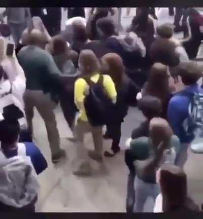Huge fight breaks out when a girl pulls and hits the boy on head.
