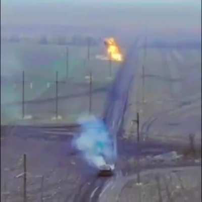 Drone footage of a Ukrainian Leopard tank firing at a Russian armored vehicle.