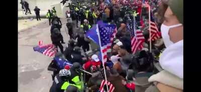 MAGA Terrorists and proud boys break bArricades and storm capital building