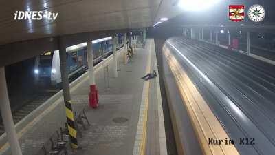 Guy jumps on train tracks to pick up cigarettes