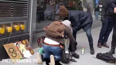 Environmental protestor falls from NY building he climbed. A can of black paint in his backpack explodes upon impact, polluting the sidewalk and gutter. (He survived)